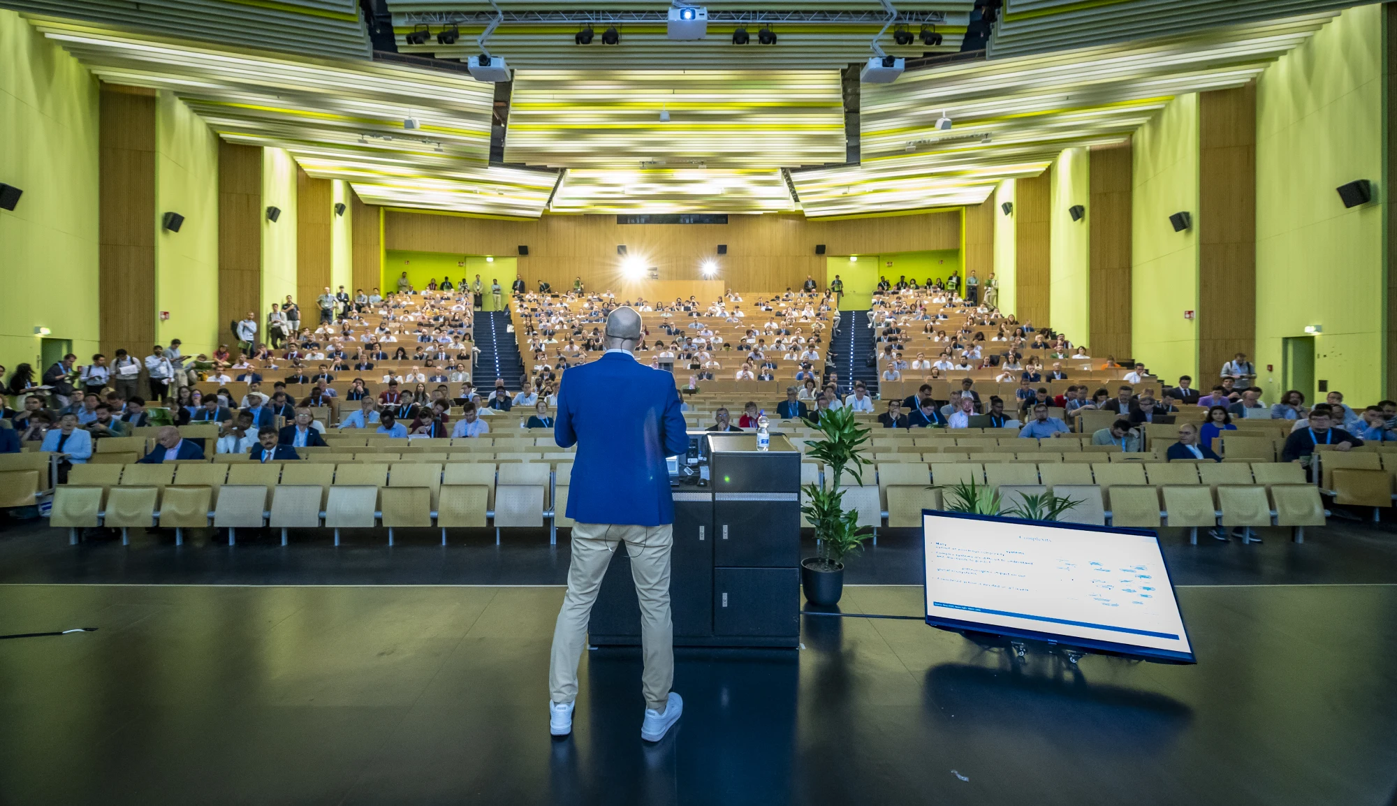 A speaker on stage and the audience at MSE 2026