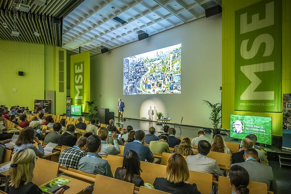 Talk and audience in the MSE 2026 auditorium with projection and stage displays
