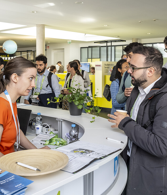The DGM-Inventum event team talking at the information desk