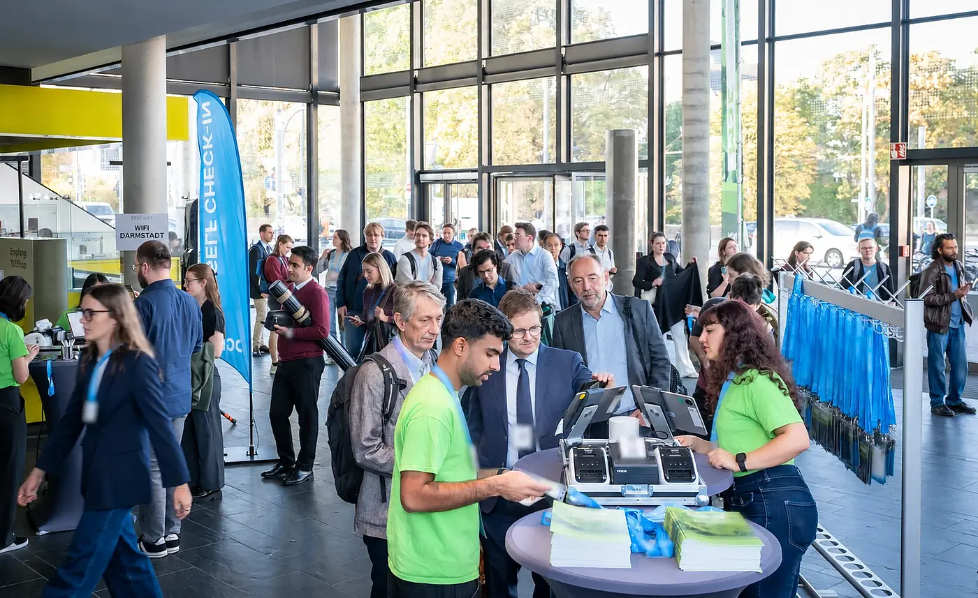 Participants arrive at several staffed check-in stations in the MSE 2026 foyer