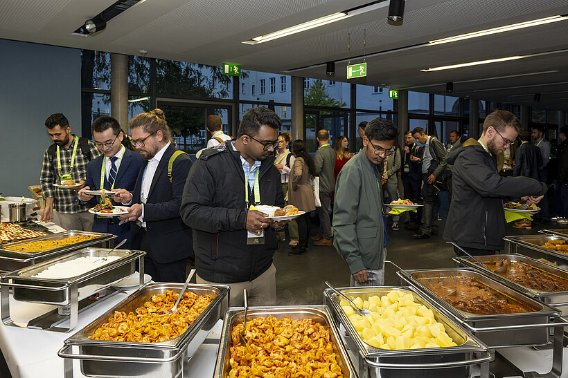 Participants choose food at an event buffet