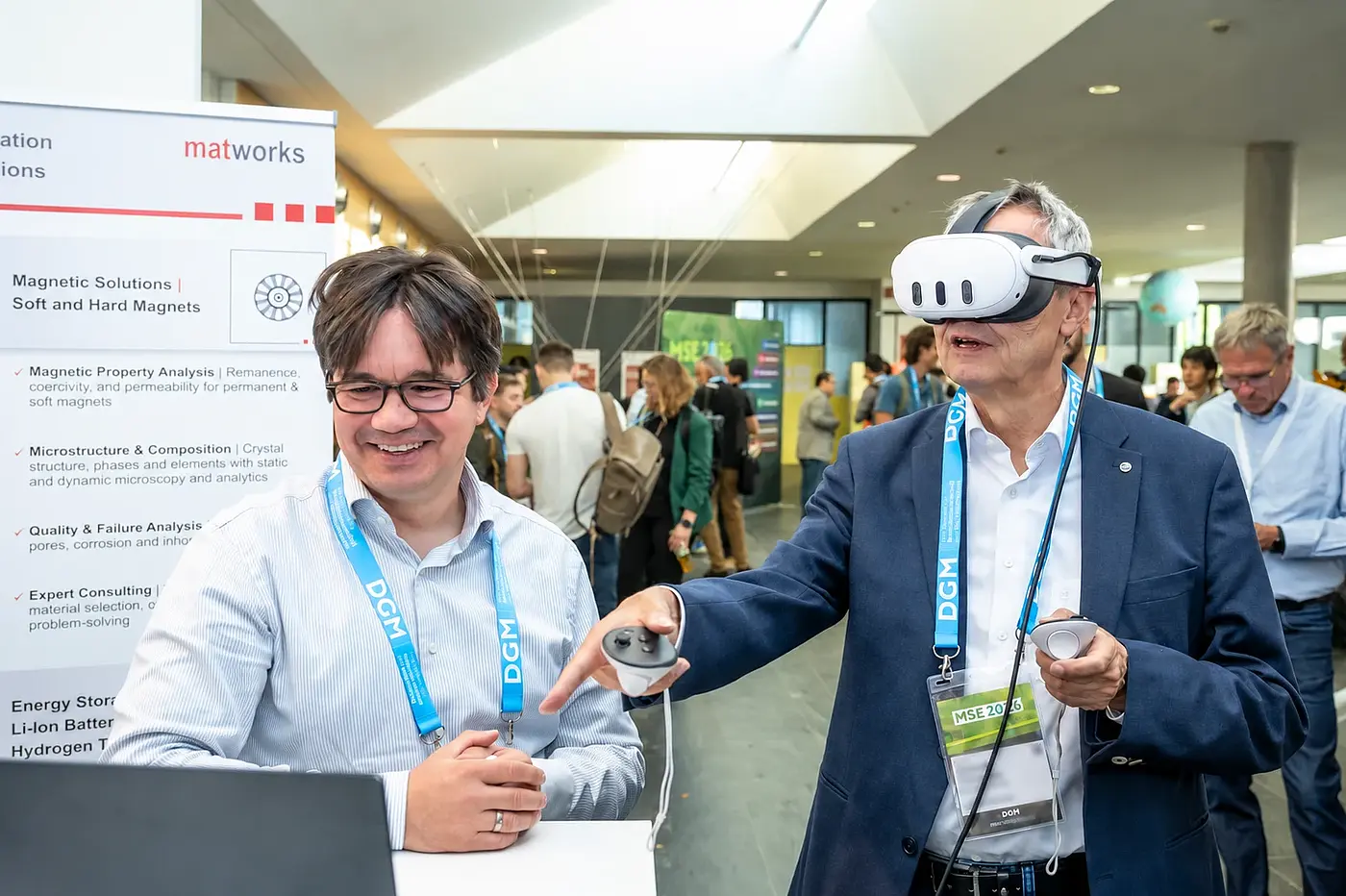Two participants try a VR application together at an exhibition booth