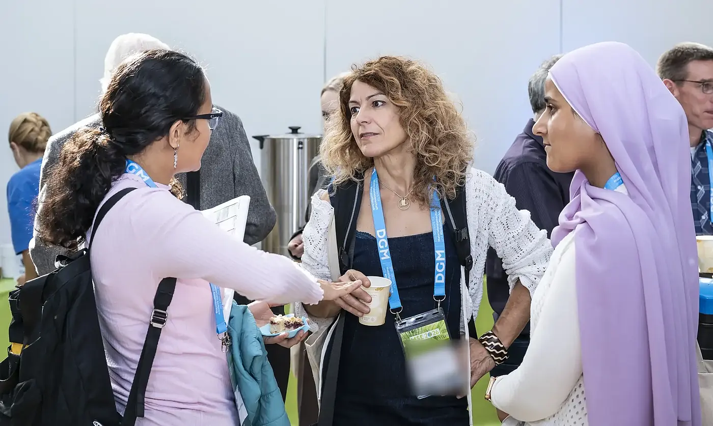Participants talk during a conference break